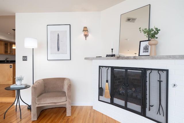 721 Madison St Unit 4N, Hoboken, NJ 07030 - sitting room featuring wood finished floors and a fireplace