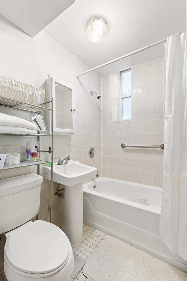 bathroom featuring shower / bath combo, tile patterned floors, and toilet