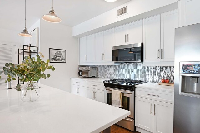 123 Jackson St Unit 4A, Hoboken, NJ 07030 - kitchen featuring stainless steel appliances, tasteful backsplash, light countertops, and white cabinetry