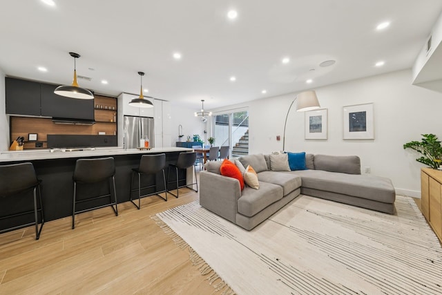 243 3rd St Unit 1, Jersey City, NJ 07302 - living room featuring light wood-style flooring, recessed lighting, and stairway