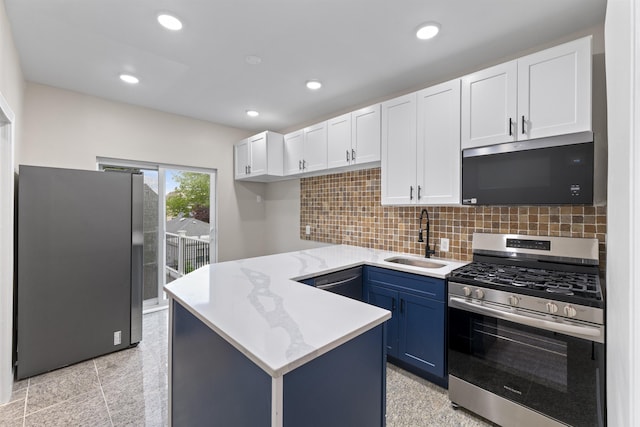 99 W 50th St, Bayonne, NJ 07002 - kitchen with stainless steel appliances, a sink, white cabinetry, a peninsula, and recessed lighting