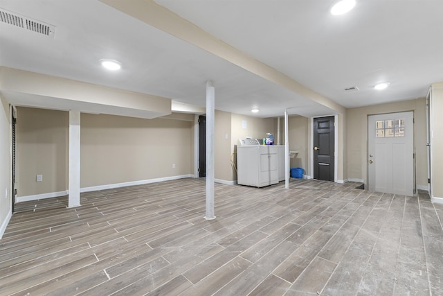 99 W 50th St, Bayonne, NJ 07002 - finished basement with washer and dryer, baseboards, light wood-type flooring, and recessed lighting