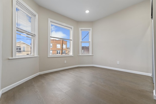 99 W 50th St, Bayonne, NJ 07002 - empty room featuring dark wood-style flooring, baseboards, and recessed lighting