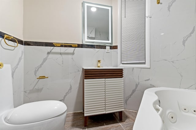 99 W 50th St, Bayonne, NJ 07002 - bathroom featuring a jetted tub, tile walls, and a sink