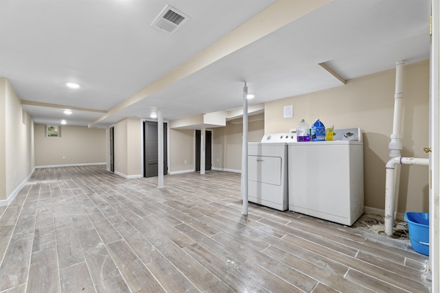 99 W 50th St, Bayonne, NJ 07002 - finished basement with washer and clothes dryer, light wood-style flooring, baseboards, and recessed lighting