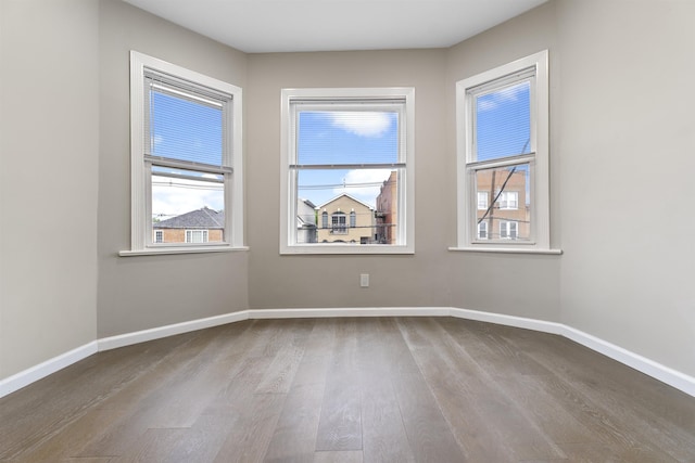 99 W 50th St, Bayonne, NJ 07002 - unfurnished room with wood finished floors and baseboards