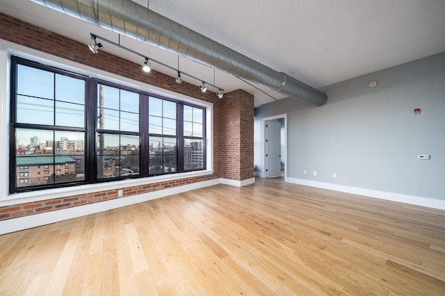 kitchen featuring decorative light fixtures, electric panel, a kitchen island, appliances with stainless steel finishes, and wall chimney exhaust hood