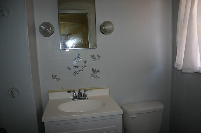 bathroom featuring toilet and vanity