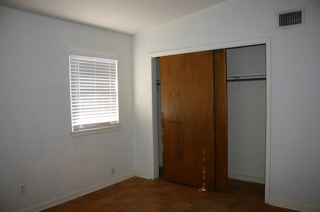 unfurnished bedroom with a closet