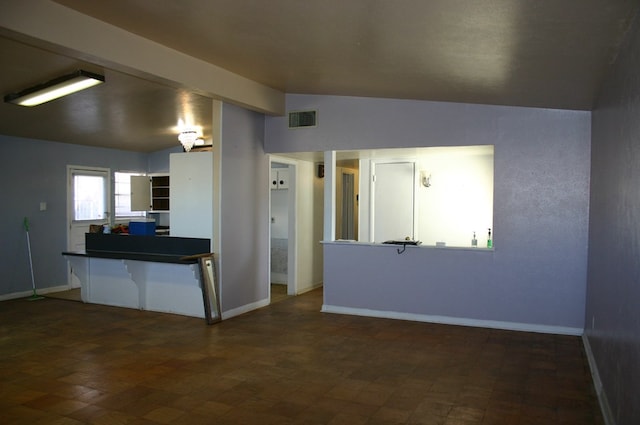 kitchen with kitchen peninsula and lofted ceiling