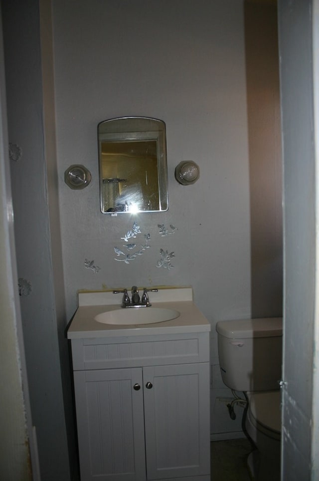 bathroom featuring toilet and vanity