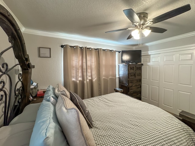 bedroom with a textured wall, ceiling fan, ornamental molding, a textured ceiling, and a closet