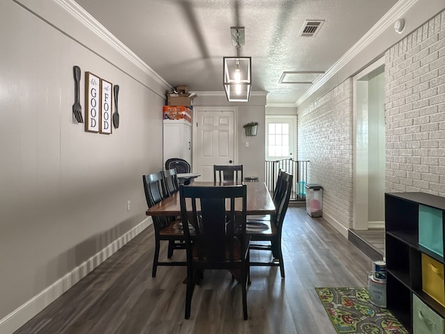 dining area featuring visible vents, dark wood-style floors, brick wall, ornamental molding, and a textured ceiling