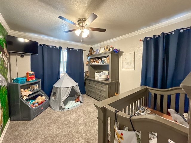 bedroom with a textured ceiling, carpet floors, a crib, and crown molding