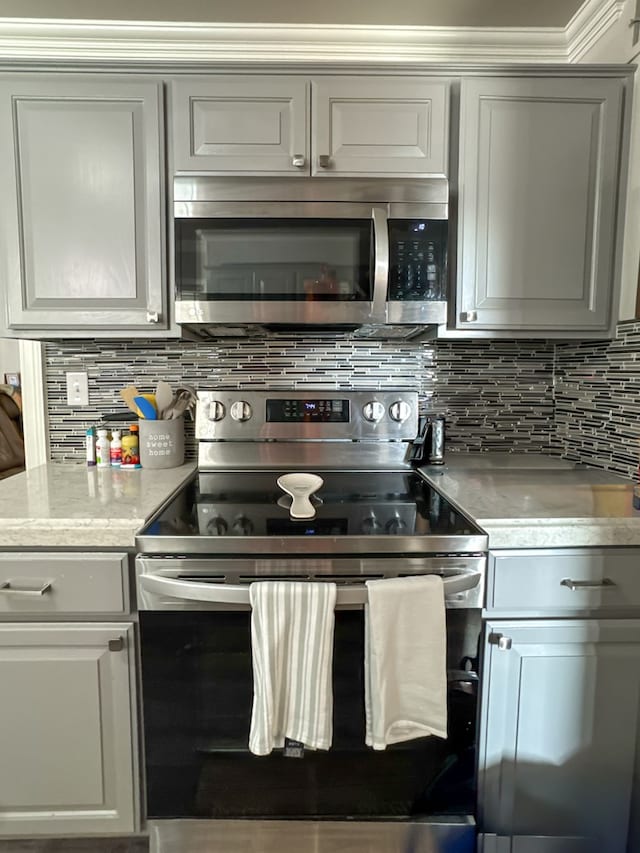 kitchen with appliances with stainless steel finishes and tasteful backsplash