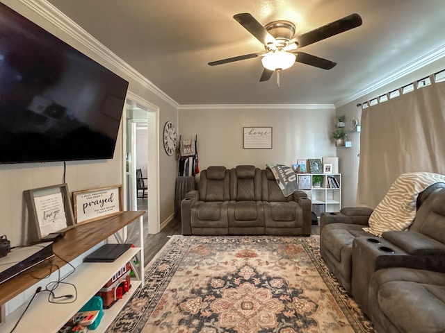 living room with wood finished floors, a ceiling fan, and crown molding