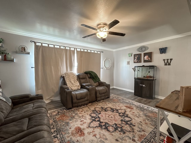 living room with dark wood finished floors, crown molding, and ceiling fan