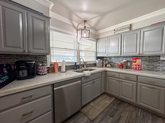 kitchen with dark wood-type flooring, a sink, stainless steel dishwasher, ornamental molding, and gray cabinets