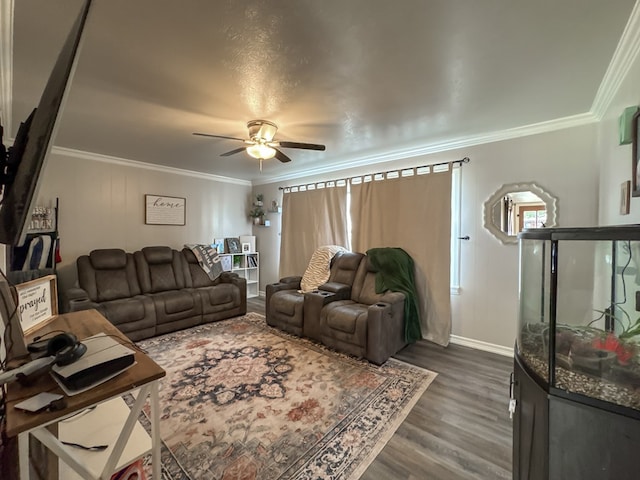 living room with dark wood-style floors, crown molding, baseboards, and a ceiling fan