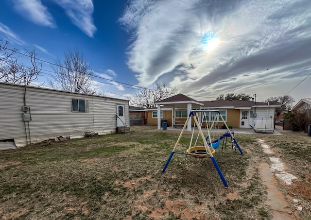 exterior space featuring a playground and a yard