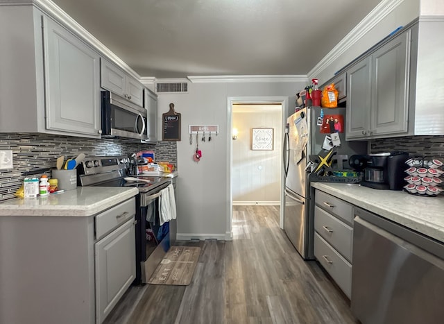 kitchen with visible vents, appliances with stainless steel finishes, backsplash, and gray cabinetry