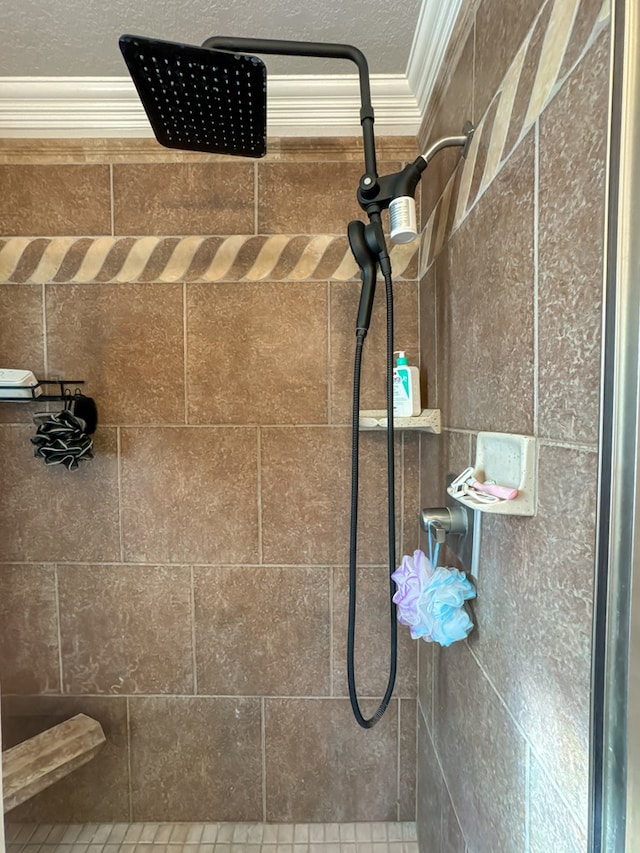 interior details featuring crown molding and a tile shower