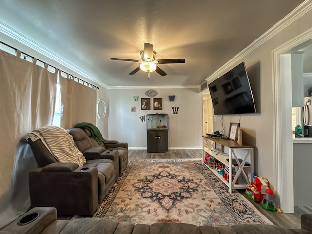 living area with baseboards, ceiling fan, ornamental molding, and wood finished floors