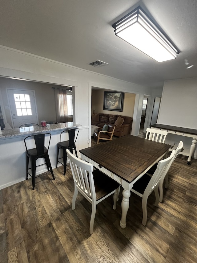 dining area with dark wood-type flooring