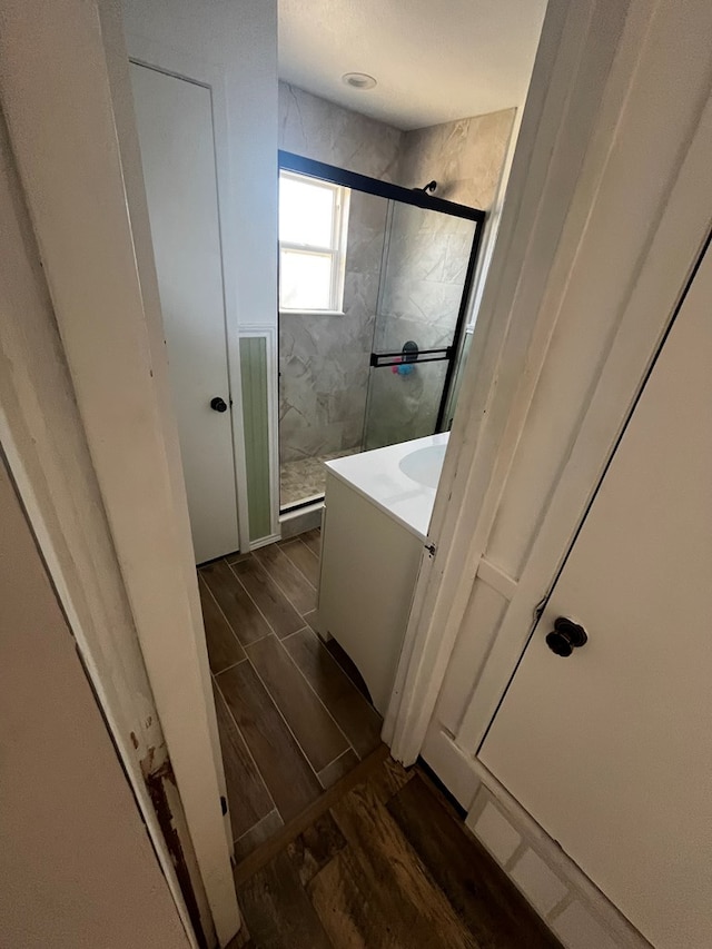 bathroom featuring walk in shower and vanity