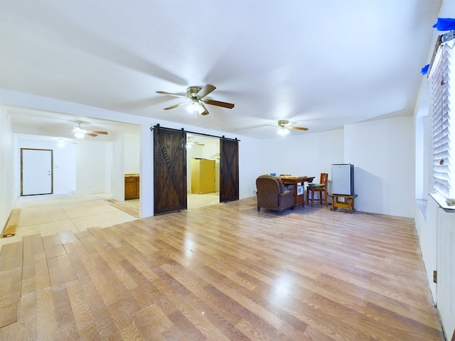 interior space with a barn door and light hardwood / wood-style flooring