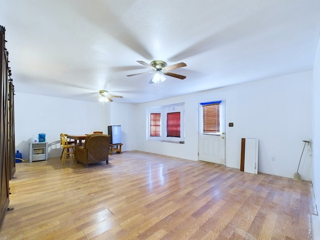 interior space with ceiling fan, light hardwood / wood-style floors, and a textured ceiling