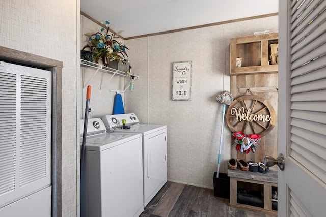 laundry room featuring laundry area, dark wood-style flooring, a heating unit, and washing machine and dryer