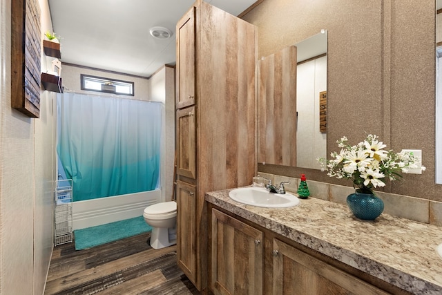 full bath featuring toilet, wood finished floors, vanity, ornamental molding, and shower / bathtub combination with curtain