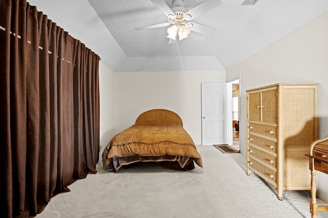 carpeted bedroom featuring ceiling fan, lofted ceiling, and a textured ceiling