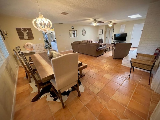 dining area with tile patterned floors, ceiling fan with notable chandelier, and a textured ceiling