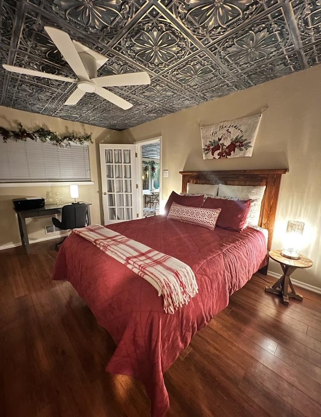 bedroom with ceiling fan and dark wood-type flooring