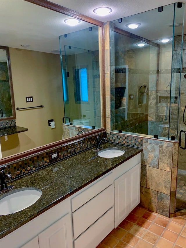 bathroom featuring tile patterned floors, vanity, and an enclosed shower