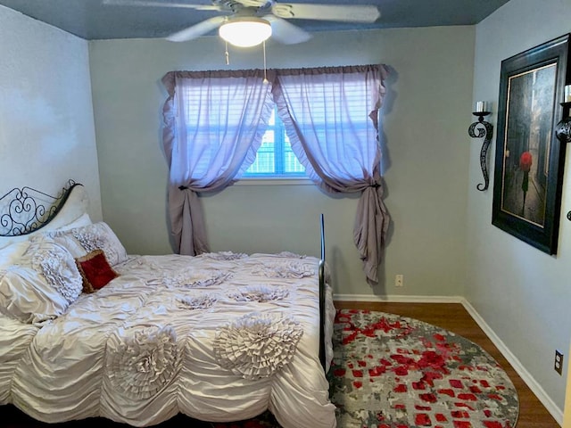 bedroom with ceiling fan and hardwood / wood-style flooring