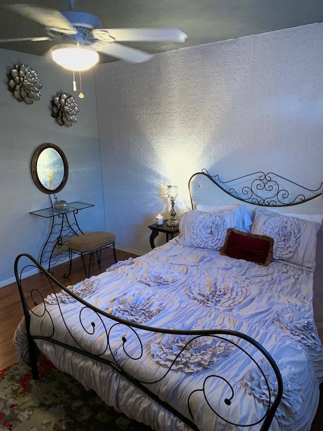 bedroom featuring hardwood / wood-style floors and ceiling fan