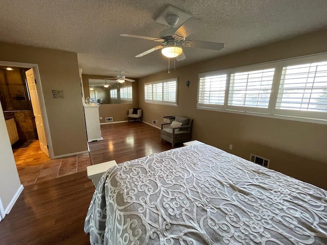 bedroom featuring a textured ceiling, dark hardwood / wood-style floors, and ceiling fan