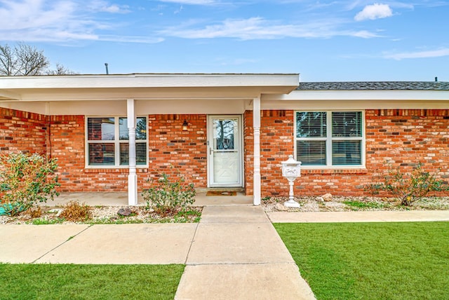 entrance to property with a yard