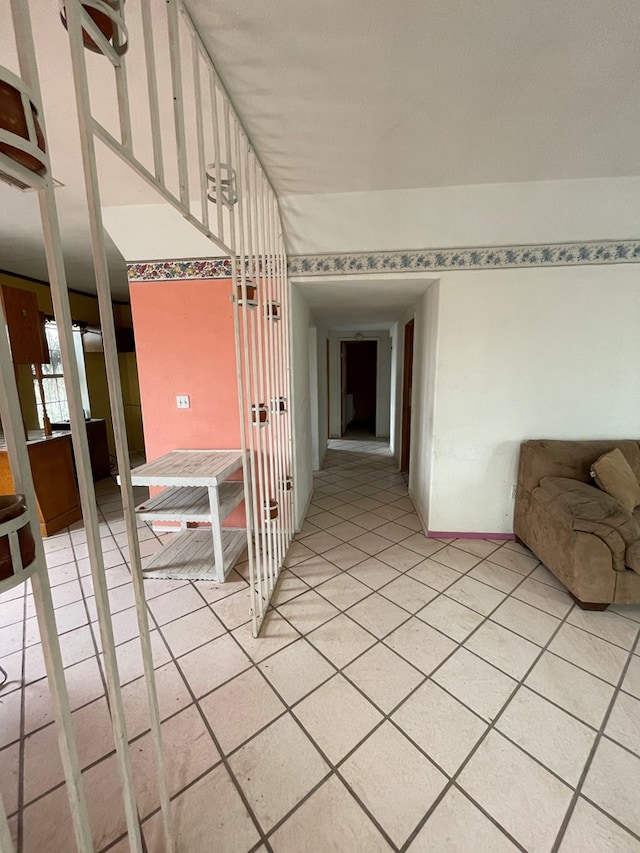 hall featuring light tile patterned floors