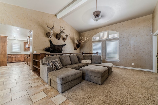 living room with vaulted ceiling with beams and ceiling fan