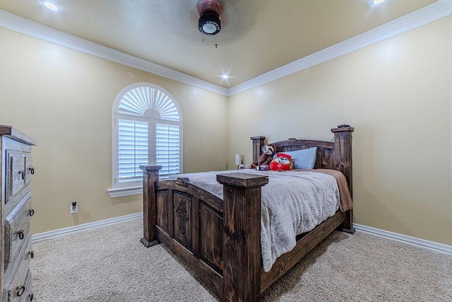 carpeted bedroom with ceiling fan and crown molding