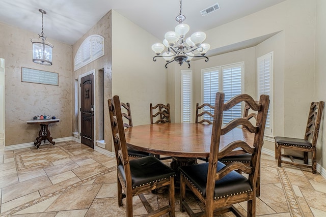 dining area with vaulted ceiling and an inviting chandelier