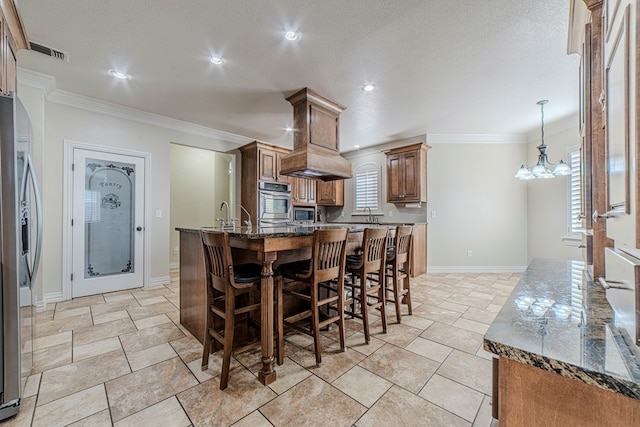 kitchen with a notable chandelier, dark stone counters, crown molding, a large island, and stainless steel fridge with ice dispenser