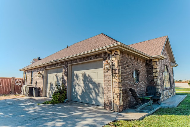 view of side of property with a garage