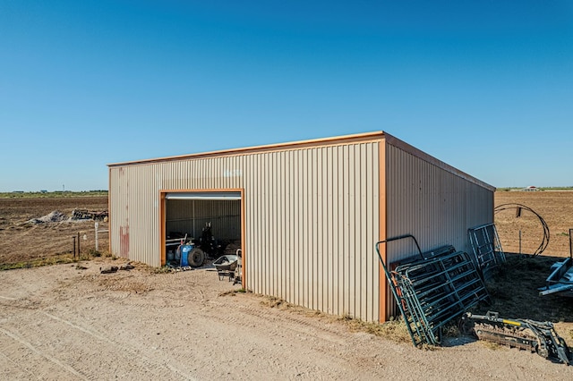 view of outbuilding with a rural view