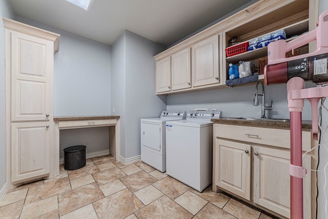 clothes washing area featuring cabinets, washer and dryer, and sink