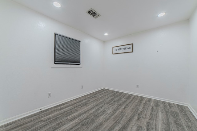 unfurnished room featuring dark hardwood / wood-style flooring